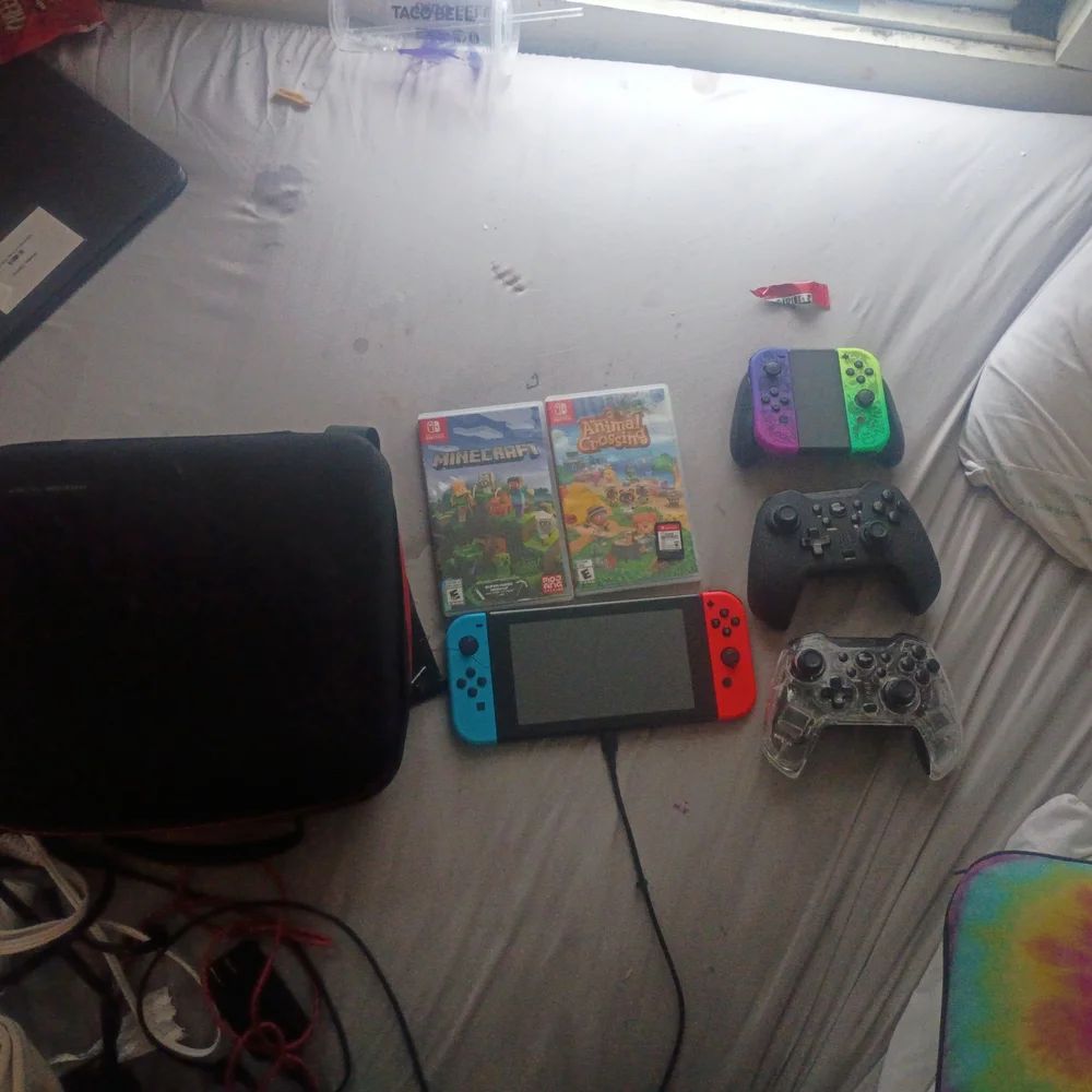 Nintendo Switch with Red and Blue Joy-Con and Multicolor Controllers